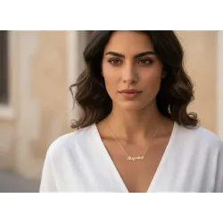 A woman's name necklace worn around the neck