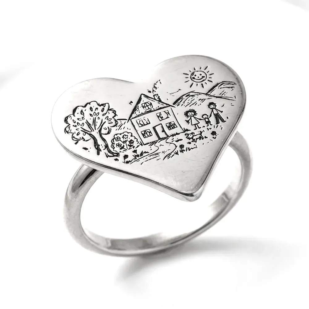 Silver ring with engraving of a children's drawing on a heart