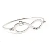 Bangle bracelet with infinity, monogram and date on platinum silver Bangle bracelet with infinity, monogram and date on platinum silver