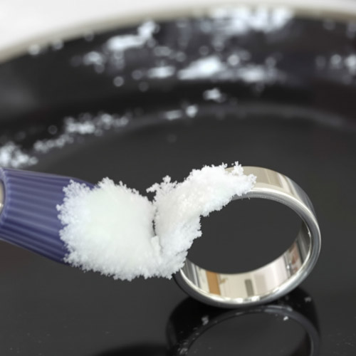 Applying baking soda paste to a sterling silver ring